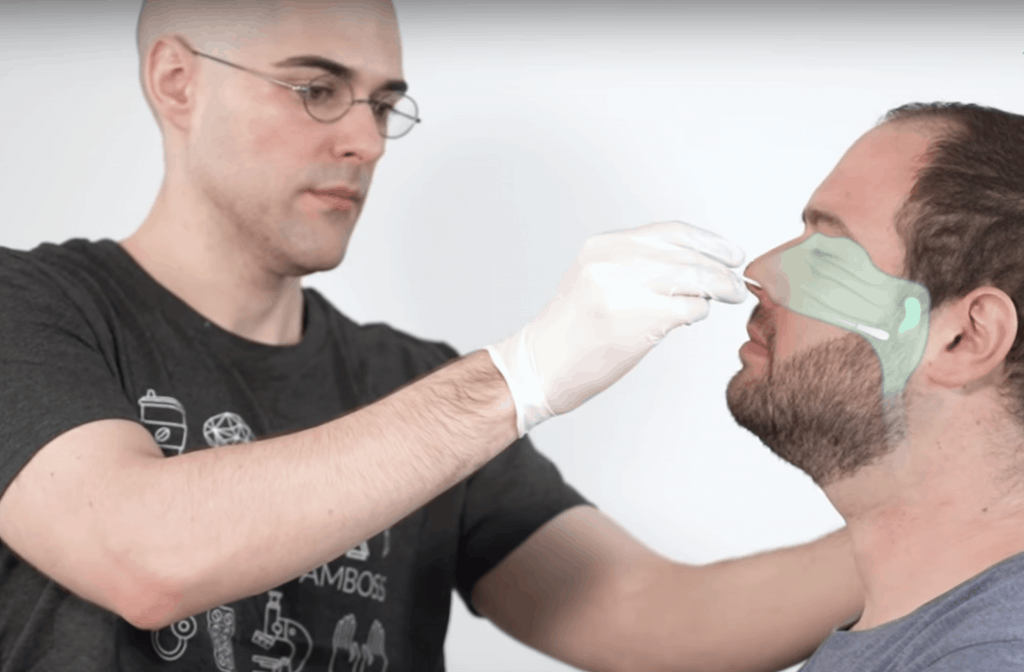 man in gloves giving nasopharyngeal swab test