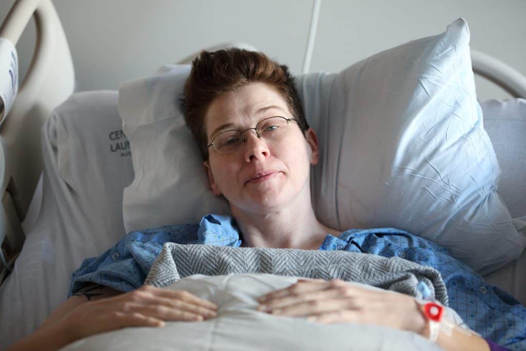 Sharon in hospital bed.