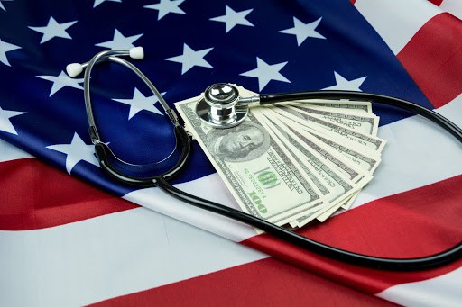 United States of America flag with black stethoscope and money on top